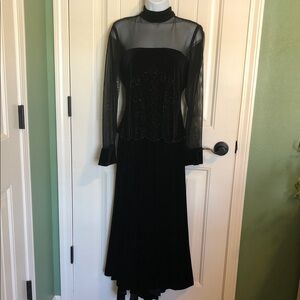 2 piece elegant black sheer long sleeve top with asymmetrical skirt.